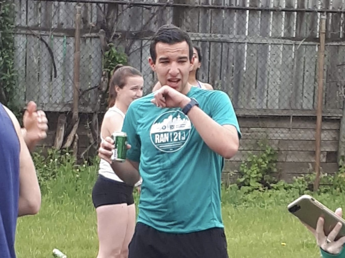 Me during the OCRC 2019 Beer Mile, making a face of disgust while holding a beer in my right hand
